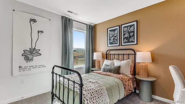 a bedroom with a bed and a painting on the wall