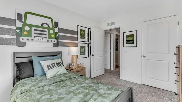 a bedroom with a bed and a television