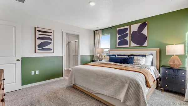 a bedroom with a bed and lamp