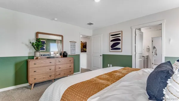 a bedroom with a bed and a dresser