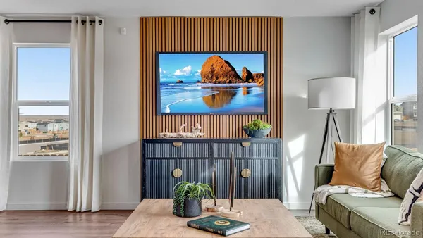 a living room with furniture and a painting on the wall