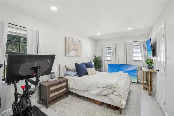 a bedroom with furniture and a wooden floor
