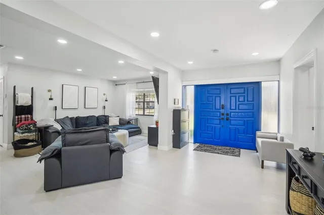 a living room with furniture gym equipment and a window