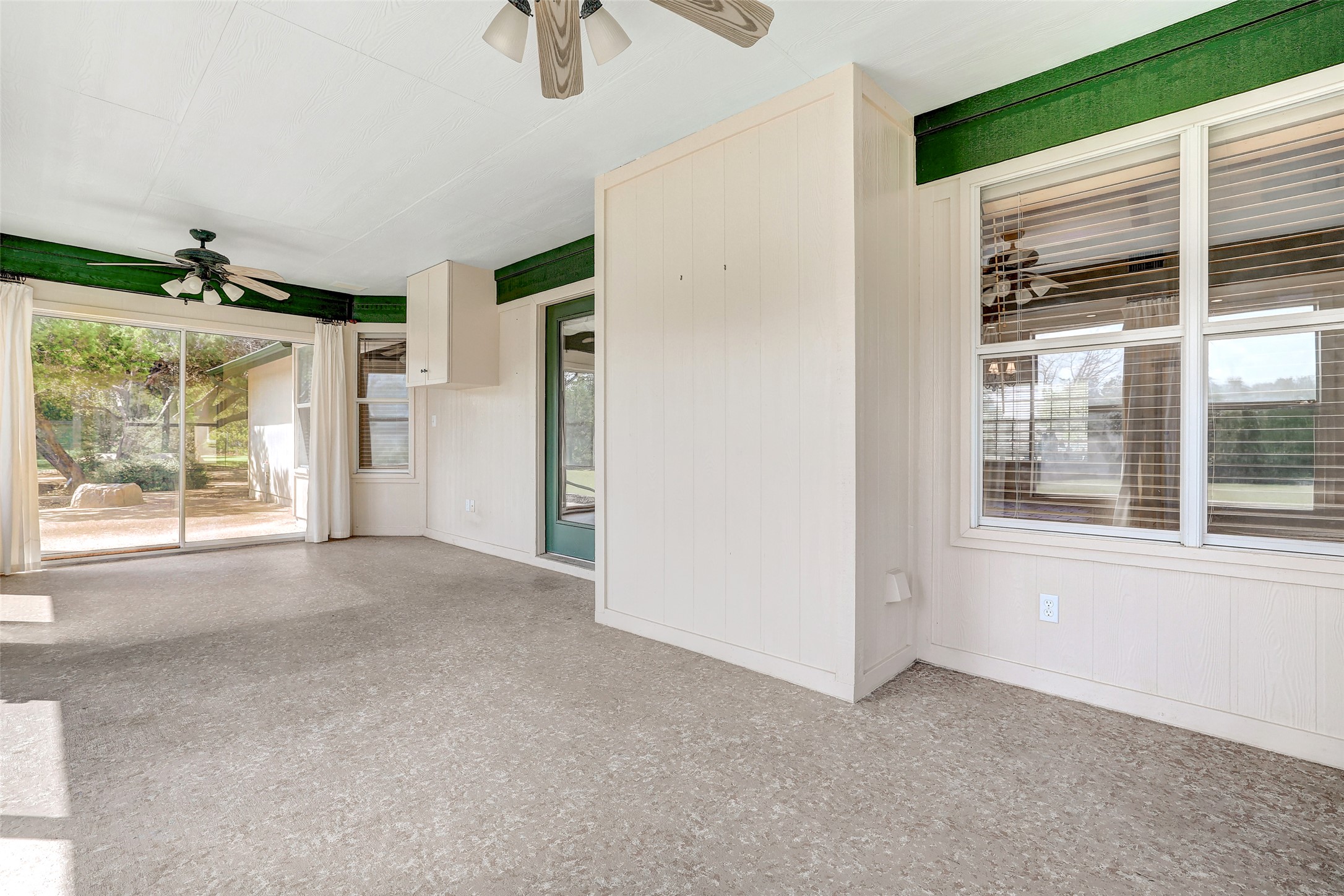 125 Kyle Lane Georgetown, TX 78633 - Photo 29 of 34 Spare room featuring a ceiling fan, plenty of natural light, and wood walls