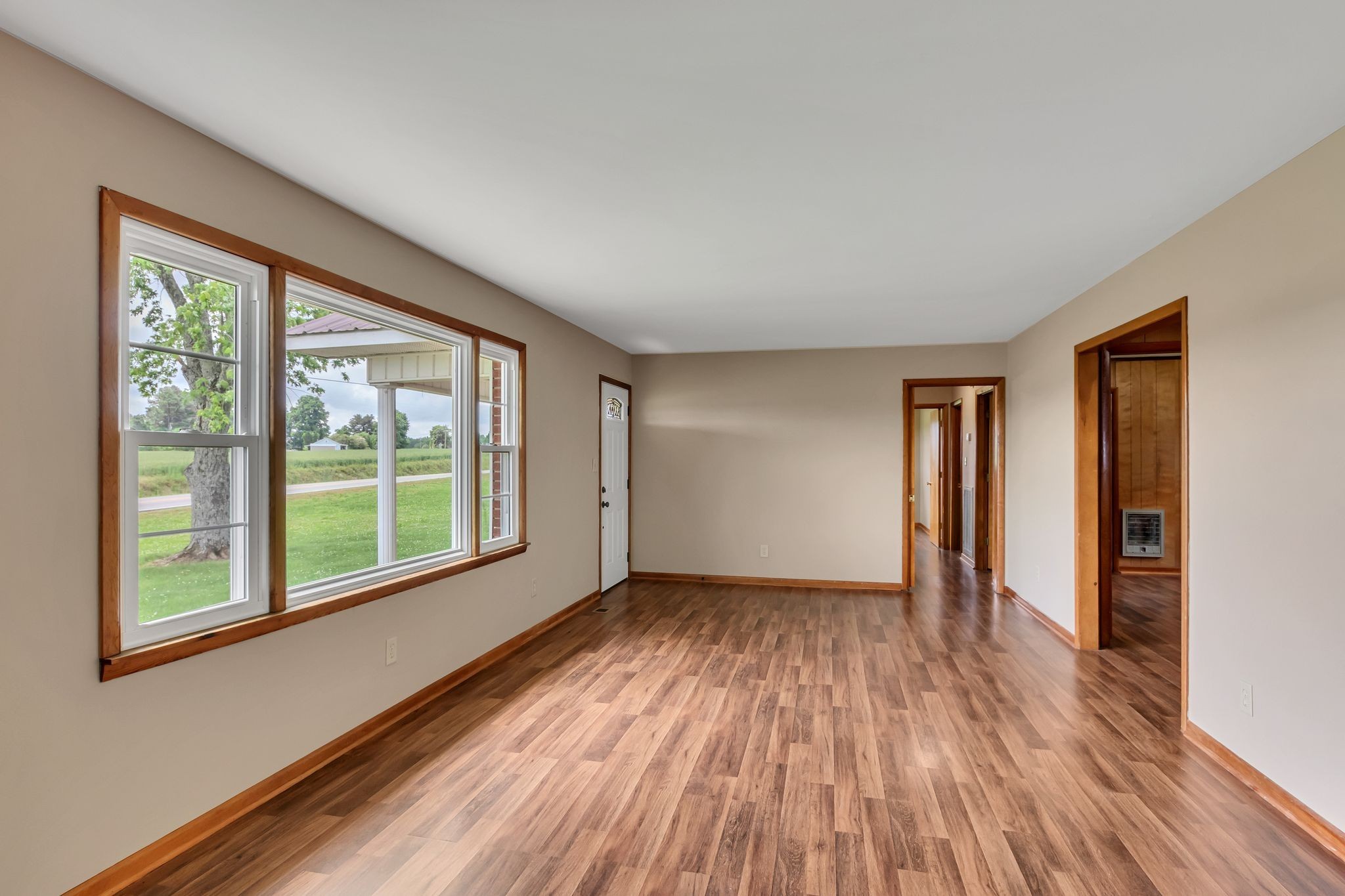 3211 Gum Creek Road Decherd, TN 37324 - Photo 11 of 35 a view of an empty room with a window and wooden floor