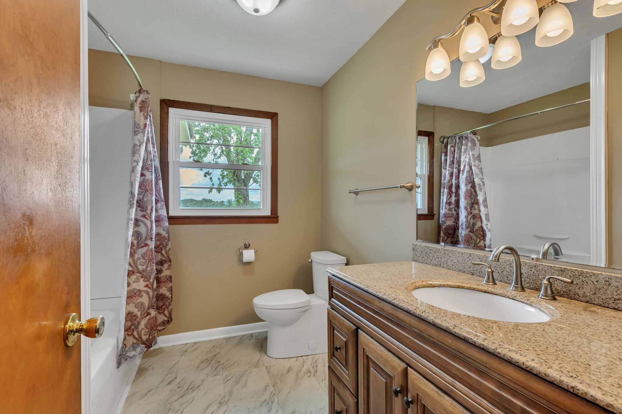 3211 Gum Creek Road Decherd, TN 37324 - Photo 17 of 35 a bathroom with a granite countertop toilet a sink and a mirror