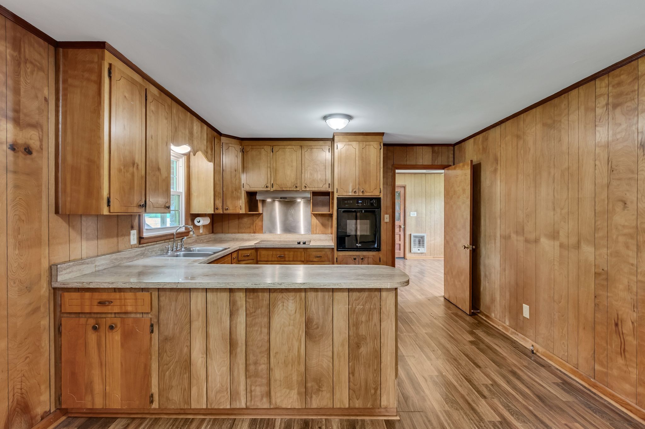3211 Gum Creek Road Decherd, TN 37324 - Photo 18 of 35 a kitchen with kitchen island granite countertop wooden cabinets a sink and stainless steel appliances