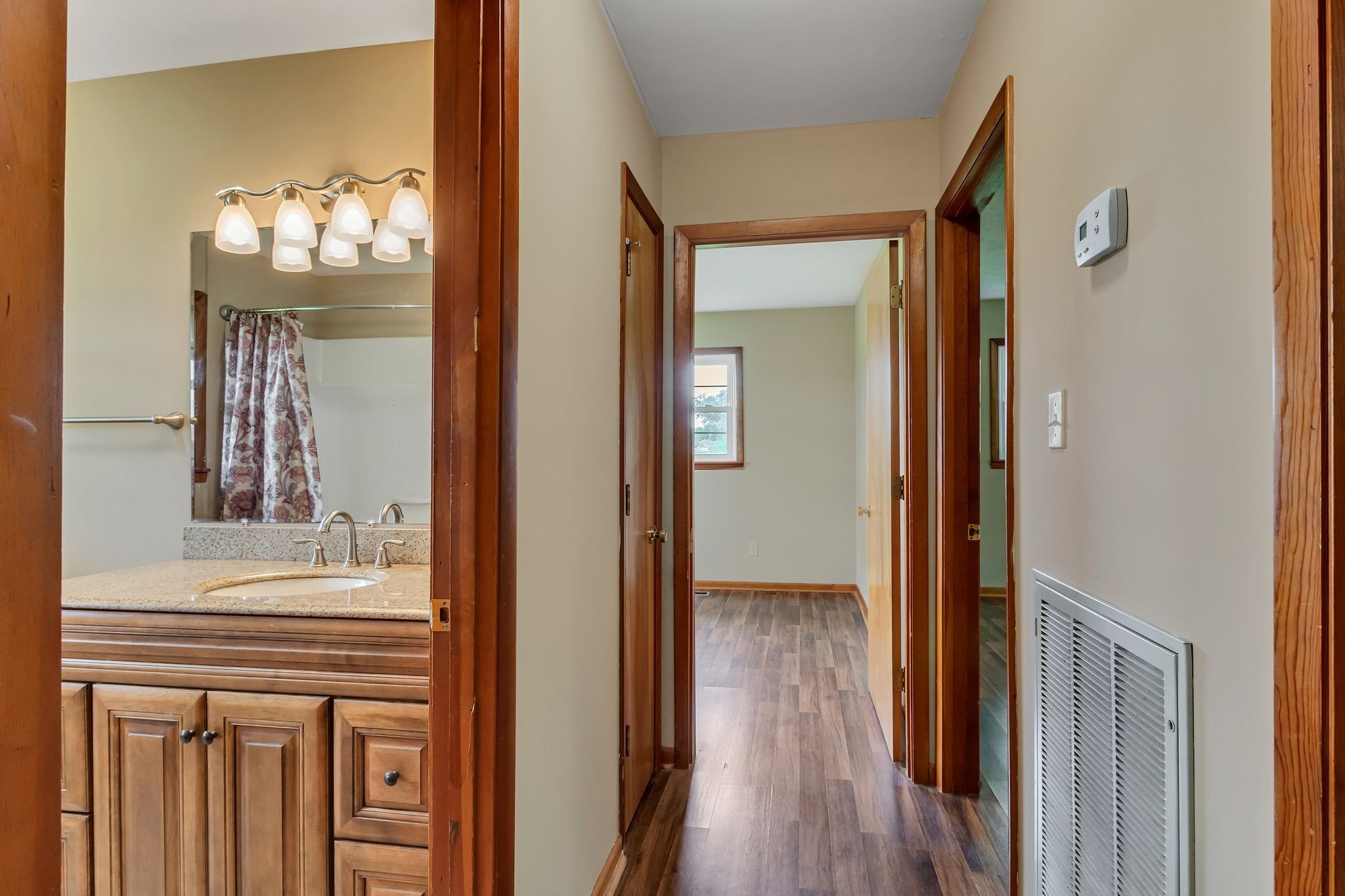 3211 Gum Creek Road Decherd, TN 37324 - Photo 22 of 35 a view of a hallway with wooden floor and a dining room