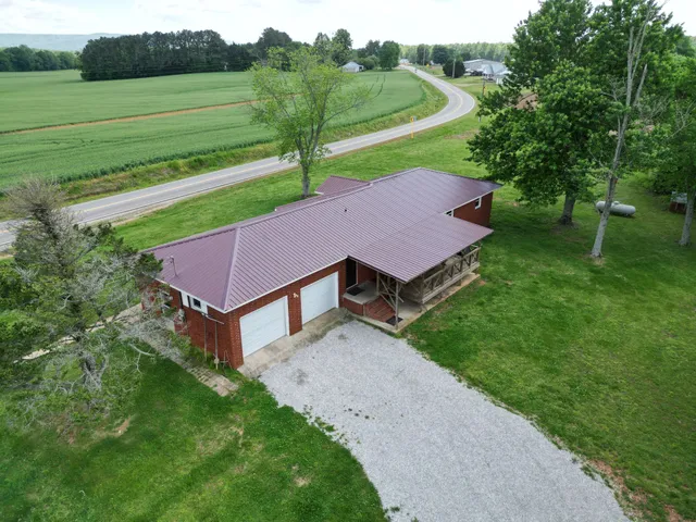 a aerial view of a house with a yard