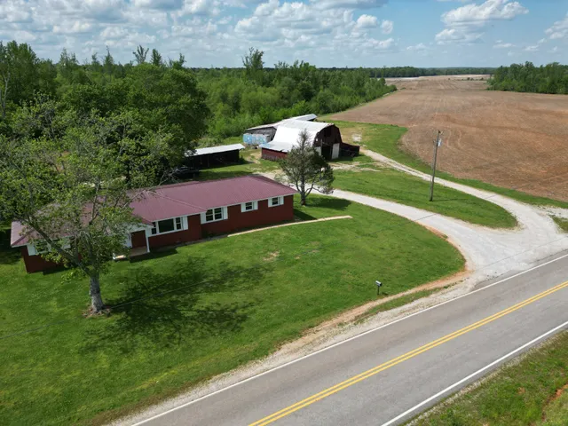 a view of a house with a yard and sitting area