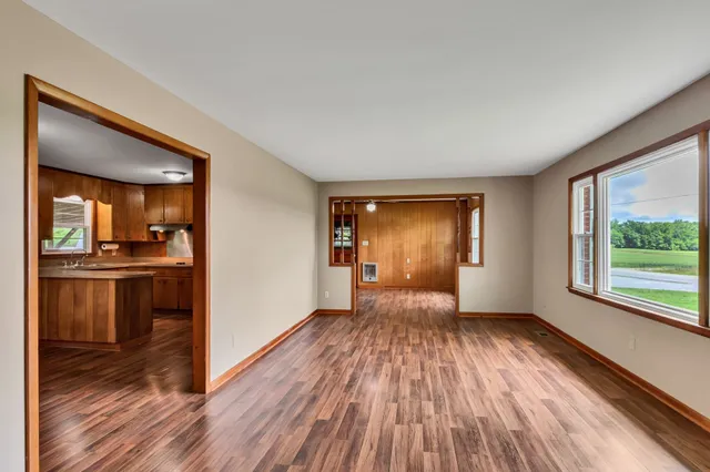 a view of a room with wooden floor and a window