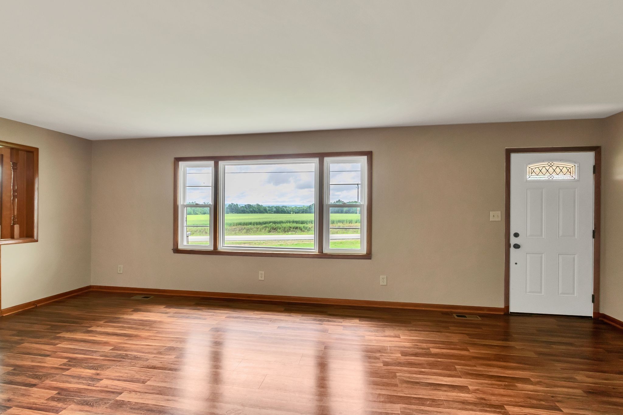 3211 Gum Creek Road Decherd, TN 37324 - Photo 10 of 35 a view of an empty room with wooden floor and a window