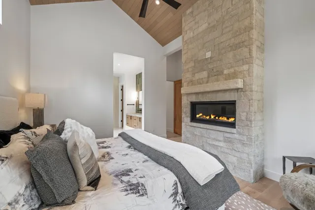 a bedroom with a bed and a fireplace