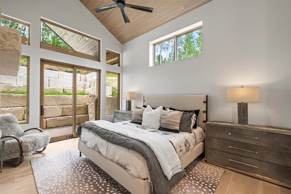 a bedroom with a bed and glass windows