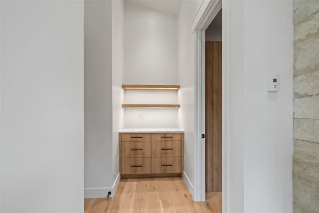 a view of walk in closet with empty racks