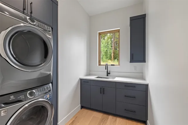 a utility room with sink dryer and washer
