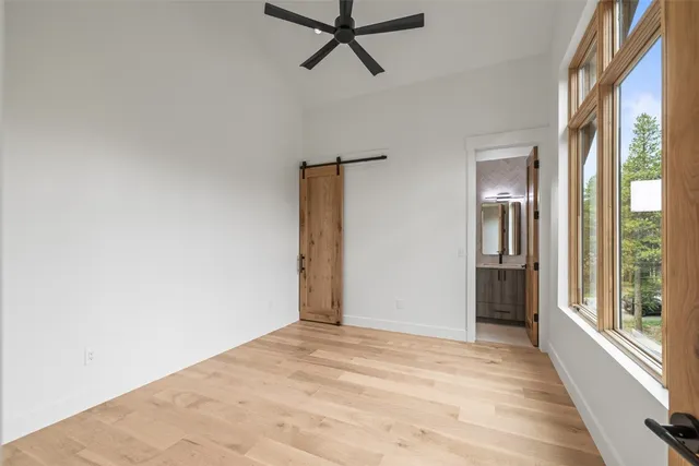 a view of a room with a ceiling fan and window