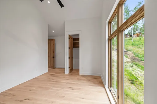 a view of a room with a ceiling fan and window