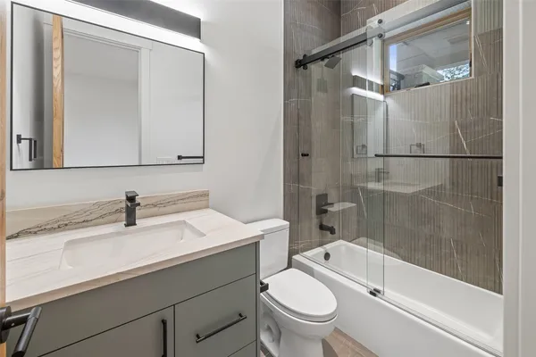 a bathroom with a sink toilet and shower