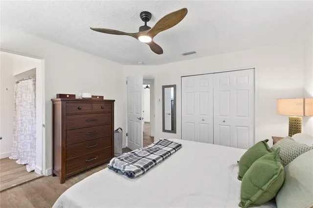 a bedroom with a bed and a dresser