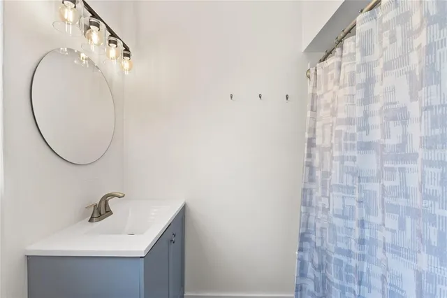 a bathroom with a sink a mirror and a shower