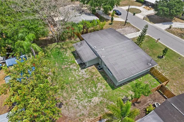 an aerial view of a house with garden space and street view