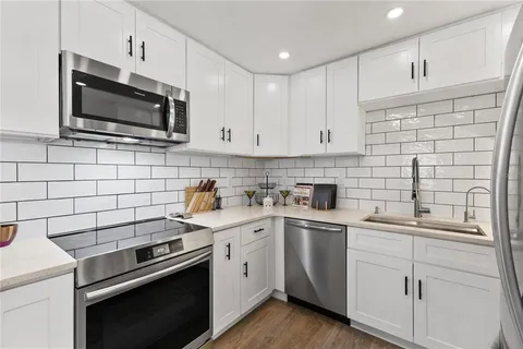a kitchen with a sink stove and microwave