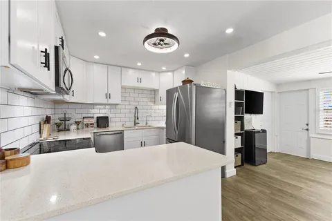 a kitchen with stainless steel appliances a refrigerator stove microwave and sink