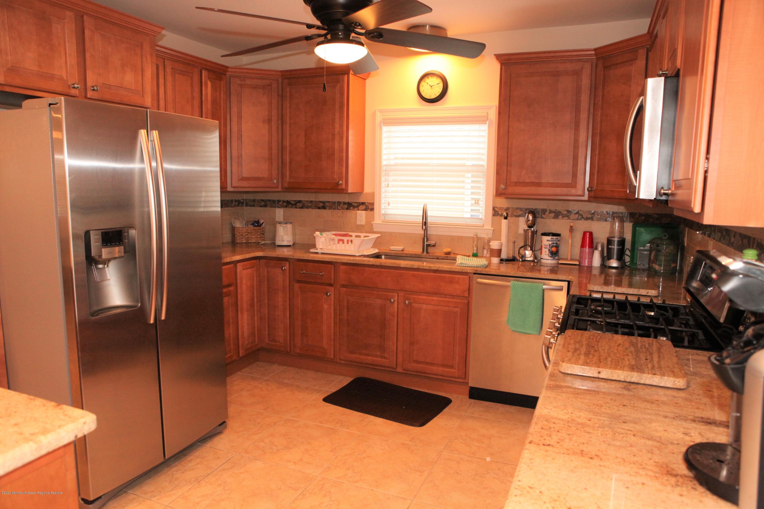 17 Colony Road Seaside Heights, NJ 08751 - Photo 20 of 37 a kitchen with stainless steel appliances granite countertop a sink a stove and a refrigerator