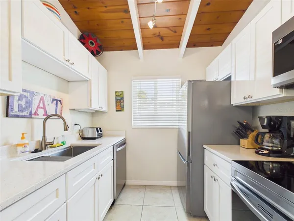 a kitchen with a sink cabinets and appliances