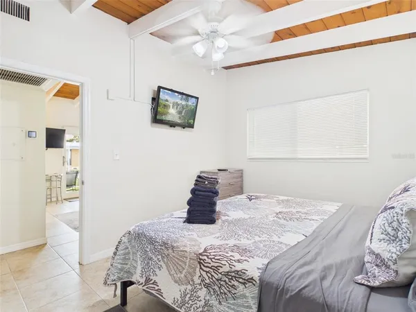 a bedroom with a bed and a chandelier