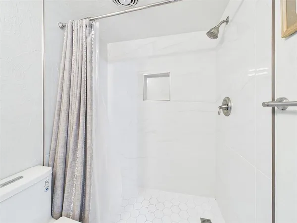 a bathroom with a shower and a toilet