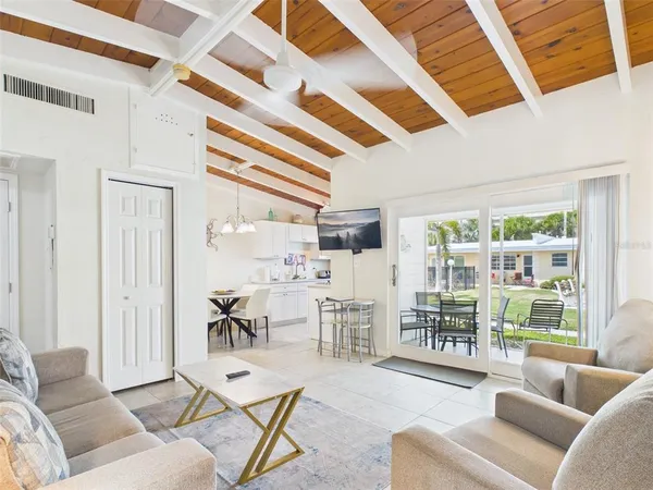 a living room with furniture and a floor to ceiling window