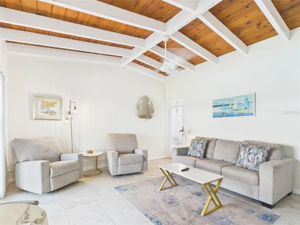 a living room with furniture and a ceiling fan