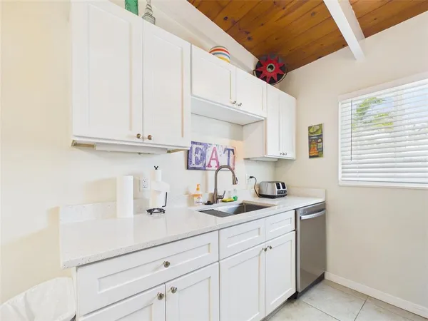 a kitchen with stainless steel appliances white cabinets and a sink
