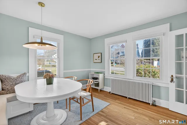 a view of a dining room with furniture window and wooden floor