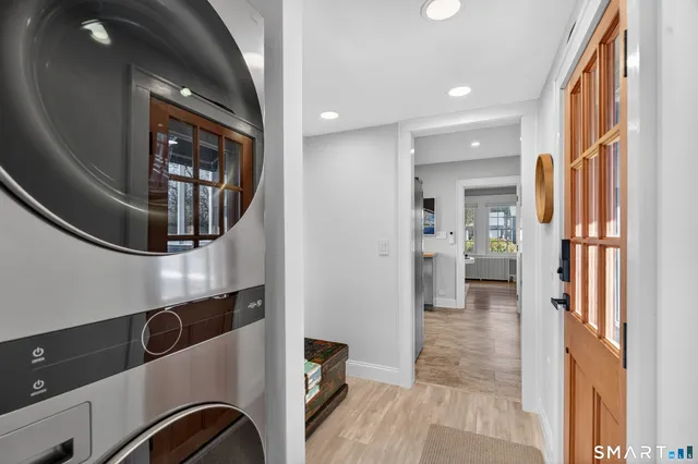 a view of a hallway with wooden floor and windows