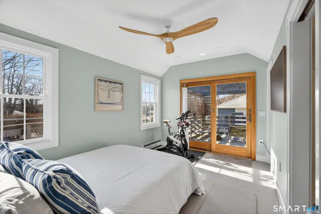 a bedroom with a large bed and a window