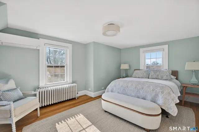 a spacious bedroom with a bed and a window