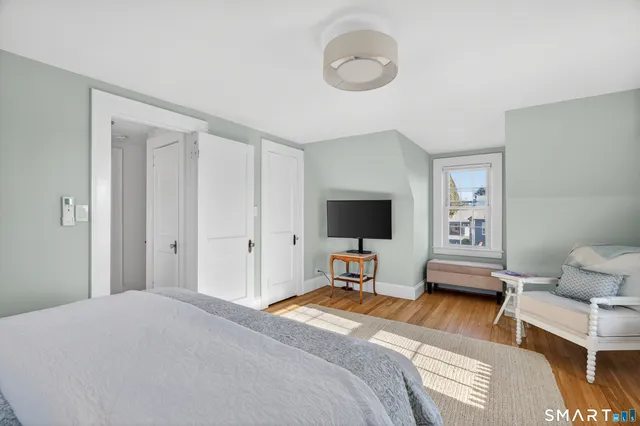 a bedroom with a bed and a flat screen tv