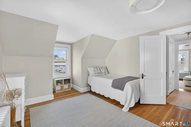 a spacious bedroom with a bed and a window