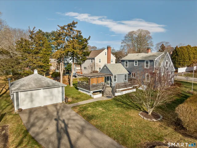 an aerial view of a house with a yard and large trees