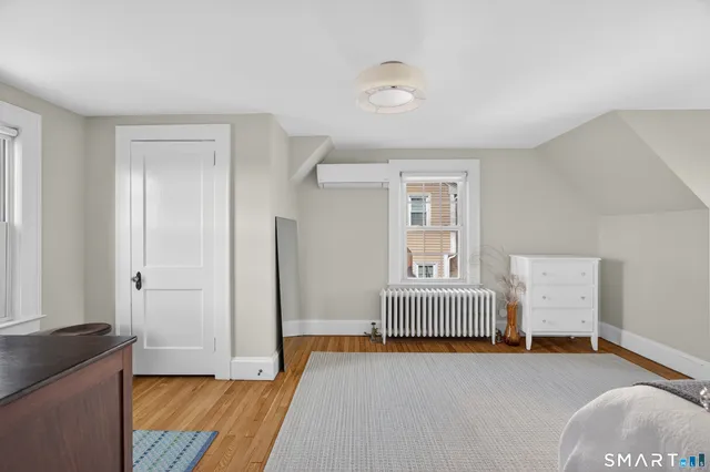 a bedroom with a bed and window