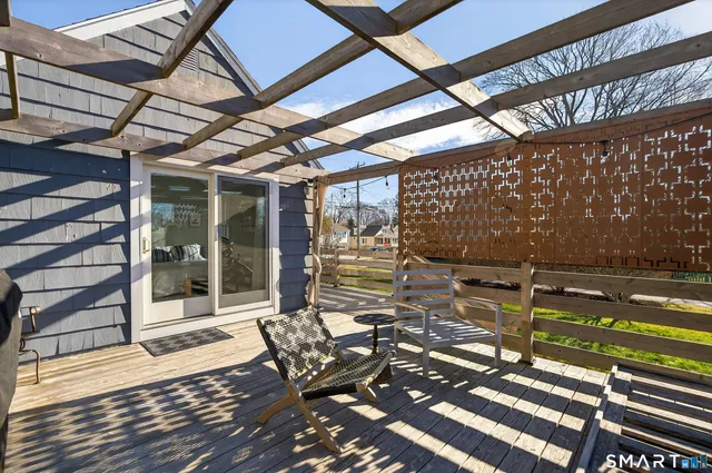 a view of a patio with table and chairs and wooden floor