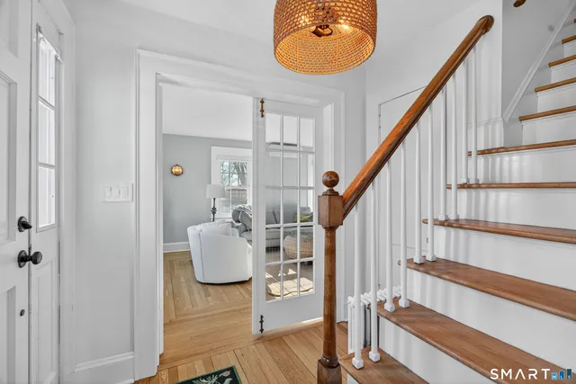 a view of entryway and hall with wooden floor