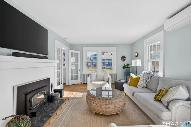 a living room with furniture a fireplace and a flat screen tv