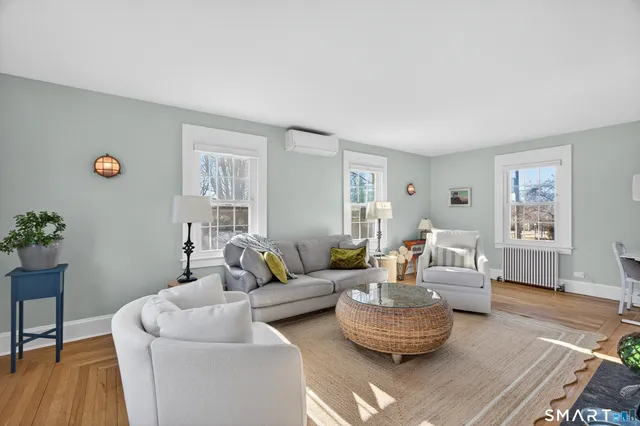 a living room with furniture and wooden floor