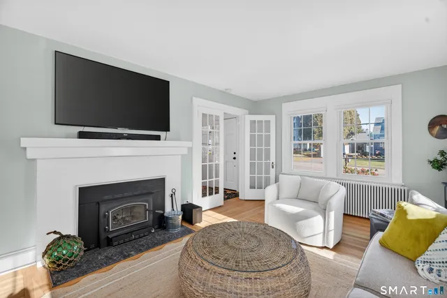 a living room with furniture a flat screen tv and a fireplace