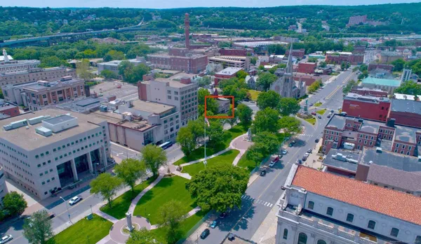 an aerial view of multiple houses with a yard