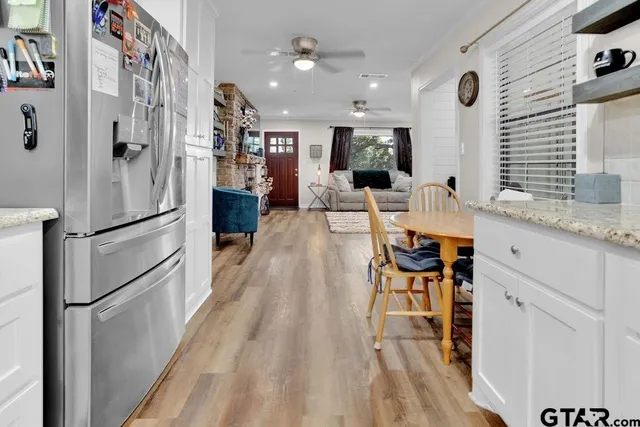 a very nice looking room with a large window and stainless steel appliances
